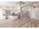 Open kitchen featuring stainless steel appliances and island with hardwood floors and views into a living room at 21313 N 59Th Dr, Glendale, AZ 85308
