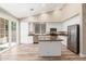 Bright kitchen featuring white cabinets, granite countertops, stainless steel appliances, and an island at 21313 N 59Th Dr, Glendale, AZ 85308