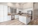 Modern kitchen featuring white cabinetry, granite countertops, an island, and stainless steel appliances at 21313 N 59Th Dr, Glendale, AZ 85308