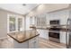 Eat-in kitchen featuring white cabinets, granite countertops and stainless steel appliances at 21313 N 59Th Dr, Glendale, AZ 85308