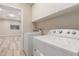 Bright laundry room featuring a washer and dryer, plus ample storage cabinets at 21313 N 59Th Dr, Glendale, AZ 85308