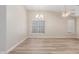 Living room with wood-look floors, neutral walls, fan and windows with blinds at 21313 N 59Th Dr, Glendale, AZ 85308