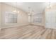 Well-lit, neutral living room with wood floors, large windows, and stylish ceiling lights at 21313 N 59Th Dr, Glendale, AZ 85308