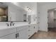 This bathroom features a double vanity with modern black fixtures and spacious countertops at 21846 E Bonanza Ct, Queen Creek, AZ 85142