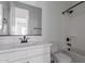 Modern bathroom with white cabinets, dark hardware, and a shower-tub combo at 21846 E Bonanza Ct, Queen Creek, AZ 85142