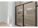Modern bathroom featuring a glass enclosed shower with a sleek design and tiled walls at 21846 E Bonanza Ct, Queen Creek, AZ 85142