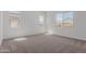 Bright bedroom with plush carpeting and ample natural light from three large windows at 21846 E Bonanza Ct, Queen Creek, AZ 85142