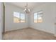 Bright dining area with large windows and a modern chandelier with tile floors at 21846 E Bonanza Ct, Queen Creek, AZ 85142