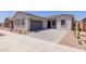 Attractive home with a gray garage door and stone driveway, showcasing modern curb appeal at 21846 E Bonanza Ct, Queen Creek, AZ 85142