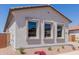 Side view of home highlighting stucco exterior and a row of windows with a rock garden at 21846 E Bonanza Ct, Queen Creek, AZ 85142
