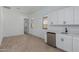 Room featuring wood-look tile floors, door to outside, sink, and beverage fridge at 21846 E Bonanza Ct, Queen Creek, AZ 85142