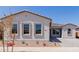 Charming single-story home with desert landscaping and a paver walkway to the front door at 21846 E Bonanza Ct, Queen Creek, AZ 85142