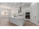 Bright, open kitchen with white cabinetry, stainless steel appliances, and a large center island at 21846 E Bonanza Ct, Queen Creek, AZ 85142