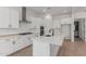 Modern kitchen with white cabinets, stainless steel appliances, and a spacious quartz countertop island at 21846 E Bonanza Ct, Queen Creek, AZ 85142