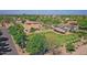 Aerial view showing a beautiful green space, well maintained fence, barn and the nearby neighborhood at 23455 S 199Th Pl, Queen Creek, AZ 85142
