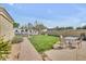 Serene backyard with lush greenery, a paved patio, and a seating area perfect for outdoor dining and relaxation at 23455 S 199Th Pl, Queen Creek, AZ 85142