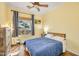 Charming bedroom with hardwood floors, a window overlooking the backyard, and a modern ceiling fan at 23455 S 199Th Pl, Queen Creek, AZ 85142