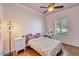 Cozy bedroom with a comfortable queen-sized bed, a ceiling fan, and natural light from the window at 23455 S 199Th Pl, Queen Creek, AZ 85142