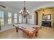 Billiard room with large windows and an ornate chandelier at 23455 S 199Th Pl, Queen Creek, AZ 85142