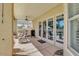 Spacious covered patio with rocking chairs, a grill, and views of the pool and well-manicured backyard at 23455 S 199Th Pl, Queen Creek, AZ 85142