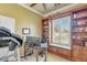 Bright home office with built-in shelves, a window seat, and a desk setup for remote work at 23455 S 199Th Pl, Queen Creek, AZ 85142