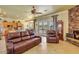 Open living area with fireplace, view of the pool, and access to the kitchen at 23455 S 199Th Pl, Queen Creek, AZ 85142