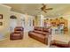 Spacious living room opens to kitchen, featuring comfortable seating and natural light at 23455 S 199Th Pl, Queen Creek, AZ 85142