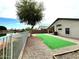 Backyard view of lake with faux grass area and gravel landscaping at 2409 N 112Th Ln, Avondale, AZ 85392