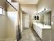 Bright bathroom with a double vanity, tile floors, and walk-in shower at 2409 N 112Th Ln, Avondale, AZ 85392