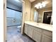 Well-lit bathroom features a vanity with a sink and a shower-tub combination at 2409 N 112Th Ln, Avondale, AZ 85392