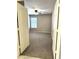 View into the bedroom with a neutral-colored walls, a ceiling fan, and a window from the doorway at 2409 N 112Th Ln, Avondale, AZ 85392
