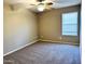 Carpeted bedroom featuring neutral-colored walls, a ceiling fan, and a window with blinds at 2409 N 112Th Ln, Avondale, AZ 85392