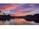 Tranquil lake view with ducks swimming and vibrant sunset at 2409 N 112Th Ln, Avondale, AZ 85392