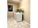 Well-equipped laundry room featuring modern washer and dryer units with overhead shelving at 2409 N 112Th Ln, Avondale, AZ 85392