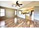 Open-concept living space showcasing wood floors and a view into the adjacent kitchen at 2409 N 112Th Ln, Avondale, AZ 85392