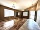 A spacious living room with wood floors, large windows, and contemporary lighting at 2409 N 112Th Ln, Avondale, AZ 85392