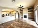 Spacious living room with a fireplace, built-in shelving, and an open view into the kitchen at 2409 N 112Th Ln, Avondale, AZ 85392