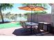 Cozy patio with outdoor seating, featuring views of the serene pond and landscaping at 2409 N 112Th Ln, Avondale, AZ 85392
