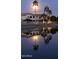 Beautiful water view with palm trees and buildings reflecting on the pond under the light of a full moon at 2409 N 112Th Ln, Avondale, AZ 85392