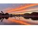 Sunset sky reflected on pond with birds, offering a serene and picturesque water view at 2409 N 112Th Ln, Avondale, AZ 85392