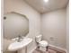Bathroom featuring a pedestal sink, an octagonal mirror, and wood-look tile flooring at 2509 W Seaver Ave, Apache Junction, AZ 85120