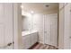 Modern bathroom with double sinks, a large mirror, and white cabinetry at 2509 W Seaver Ave, Apache Junction, AZ 85120