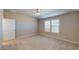Spacious carpeted bedroom with ample natural light from two windows, and a ceiling fan at 2509 W Seaver Ave, Apache Junction, AZ 85120