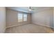 Bright, carpeted bedroom with a ceiling fan and two windows that provide plenty of natural light at 2509 W Seaver Ave, Apache Junction, AZ 85120