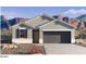 New home showing a two-car garage, stylish curb appeal, and desert landscape at 2509 W Seaver Ave, Apache Junction, AZ 85120