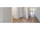 Hallway with doors leading to different rooms featuring wood-look vinyl flooring at 2509 W Seaver Ave, Apache Junction, AZ 85120