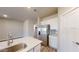 A well-lit kitchen with stainless steel refrigerator and island with quartz countertop at 2509 W Seaver Ave, Apache Junction, AZ 85120