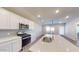 A modern kitchen features stainless steel appliances, quartz countertops, and white cabinetry at 2509 W Seaver Ave, Apache Junction, AZ 85120