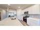 Modern kitchen with stainless steel appliances, quartz countertops, and white cabinetry at 2509 W Seaver Ave, Apache Junction, AZ 85120