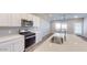 A modern kitchen features stainless steel appliances and an island with a sink at 2509 W Seaver Ave, Apache Junction, AZ 85120